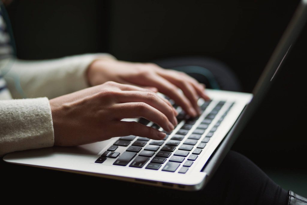 Hands on laptop keyboard