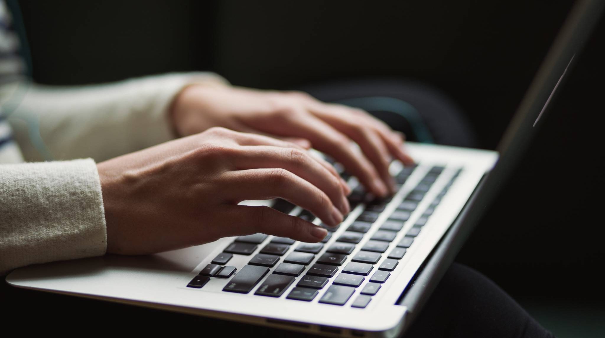 Hands on laptop keyboard