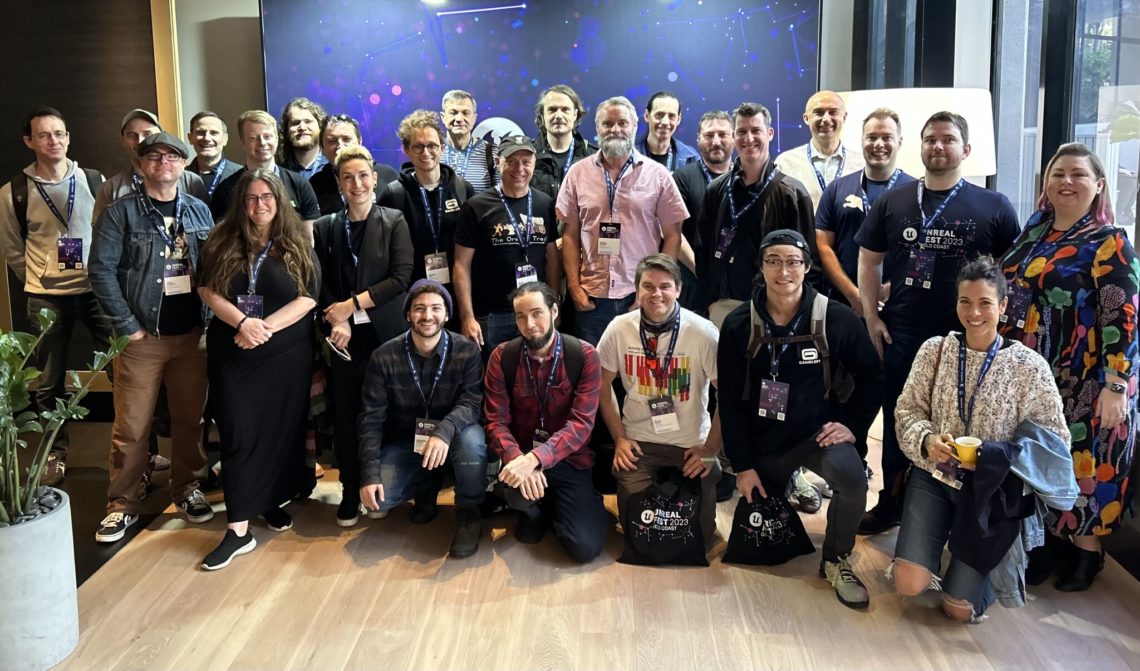 A group photo of the Gameloft Brisbane team. they are smiling together and wearing lanyards at Unreal Fest