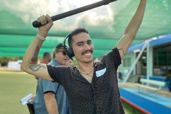 Film Intensive Script to Screen participant smiling and holding a boom over his head
