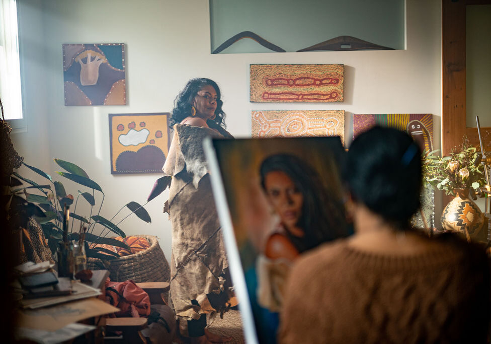 A photo of a woman being painted.