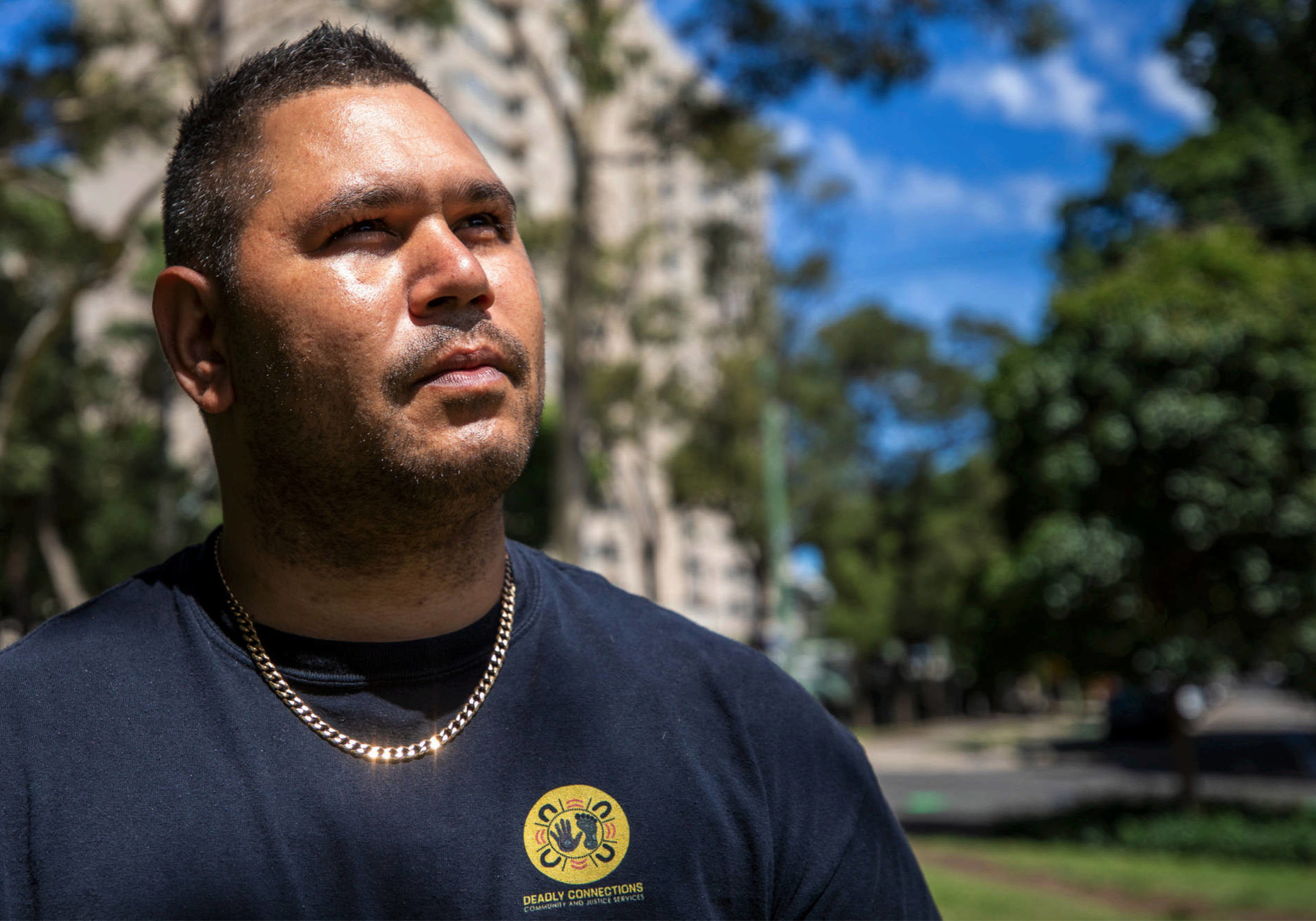 Keenan Mundine is pictured looking up. he wears a black shirt that says 'Deadly Connections'. From film INCARCERATION NATION