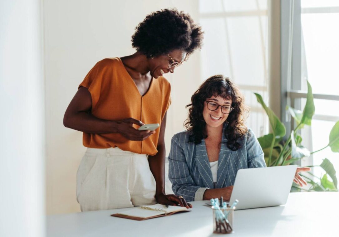 Happy,Professional,Women,Collaborating,With,Enthusiasm,In,A,Modern,Office